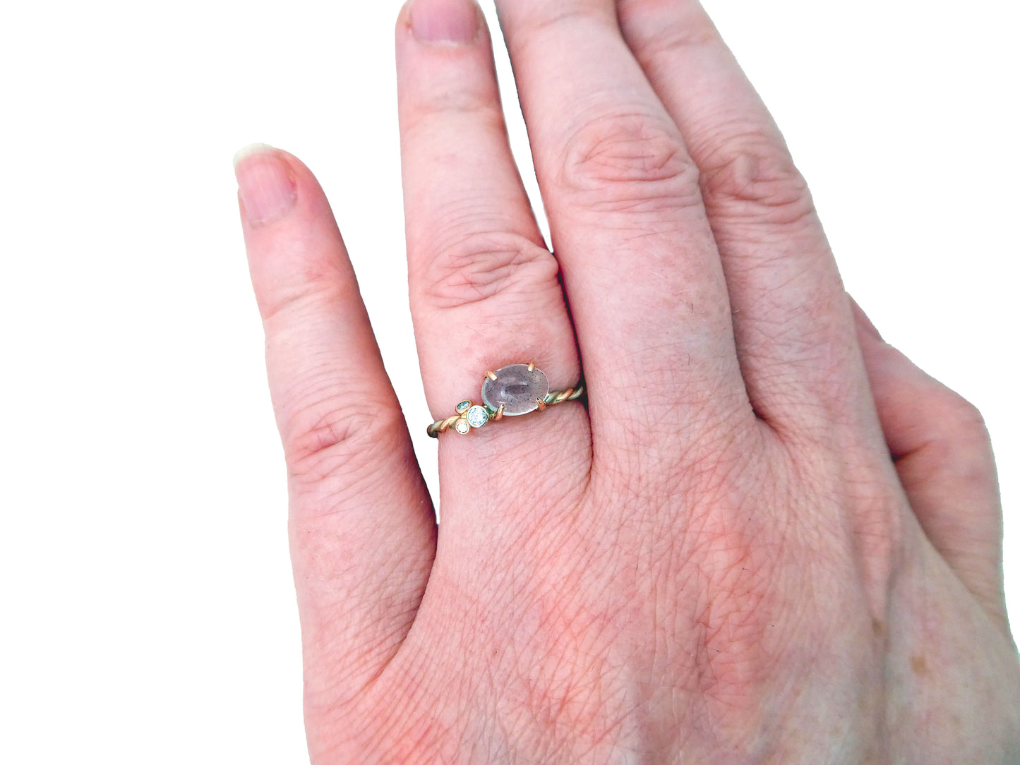 Moonstone 4-Prong White and Rose Gold Ring 5x7mm, east-west oval cabochon with clustered diamonds and a two-tone twist band, size 6