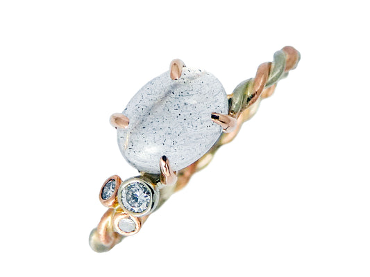Moonstone 4-Prong White and Rose Gold Ring 5x7mm, east-west oval cabochon with clustered diamonds and a two-tone twist band, size 6