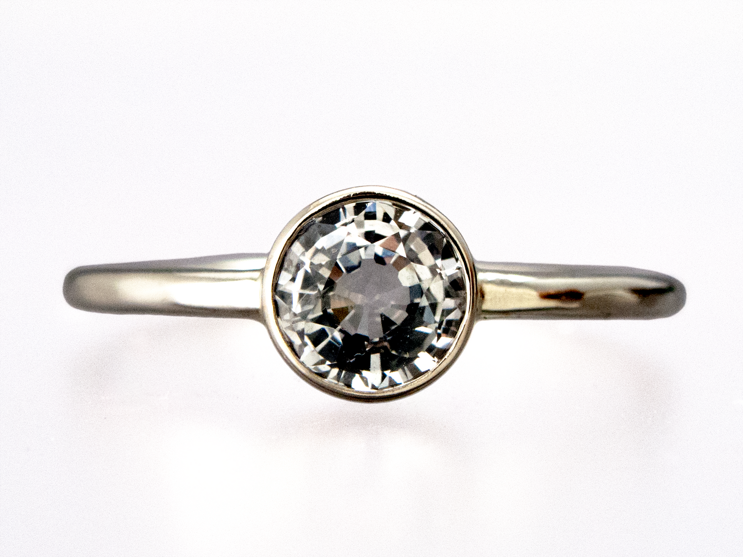 White Sapphire Engagement Ring, Round Straight Sided Bezel and a Delicate 1.3mm Round Band | 3-6mm Sapphire in 14k Gold