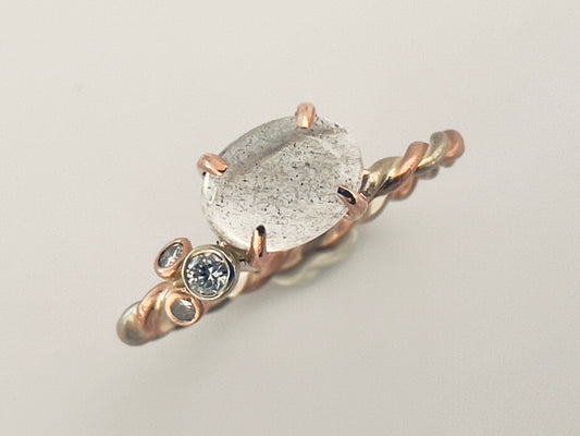 East-West Oval Moonstone 4-Prong White and Rose Gold Ring with clustered diamonds and a two-tone twist band, size 6