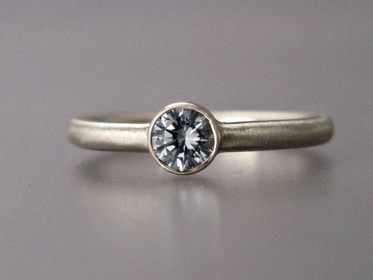 Solitaire Moissanite Engagement Ring with Straight Bezel and a Classic 2mm Round Band in Gold or Platinum | 3mm-6mm Lab Grown Diamond Alternative